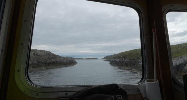 View from the window of a boat down a narrow natural channel.